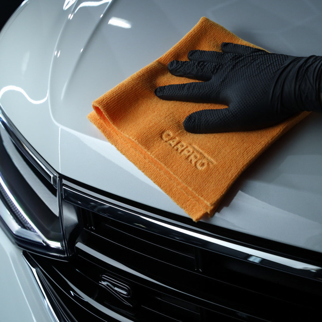 CarPro 2 Face No-Lint Microfibre Cloth - orange cloth buffing a panel