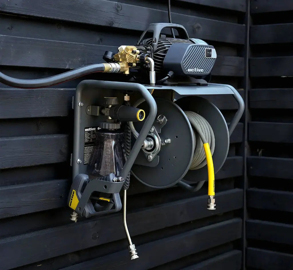 Active pressure washer wall mount kit installed on a dark timber wall with hose fitted