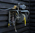 Active pressure washer wall mount kit installed on a dark timber wall with hose fitted