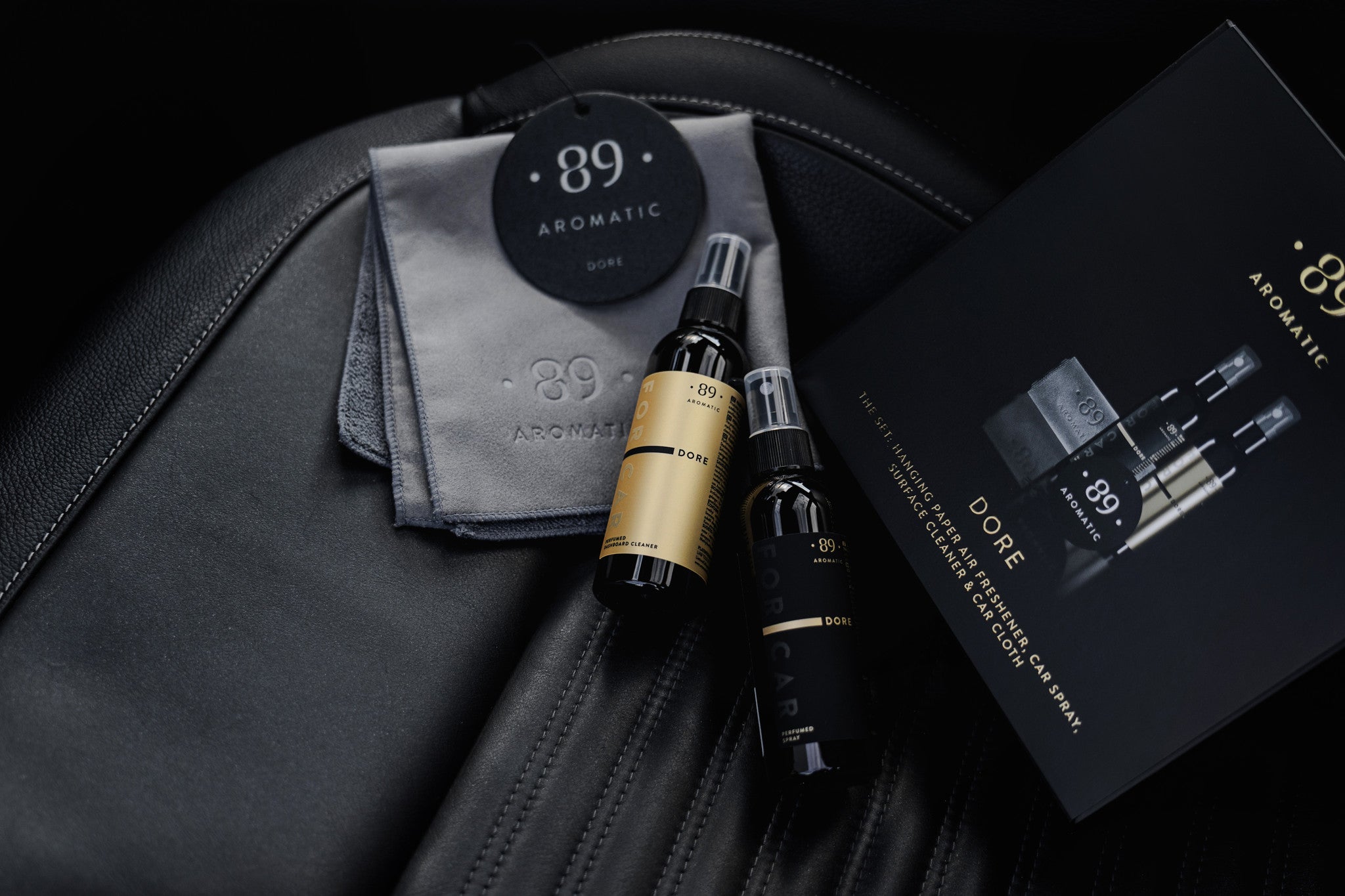 Aromatic 89 Car Care Set Dore, full set laid out on a leather seat