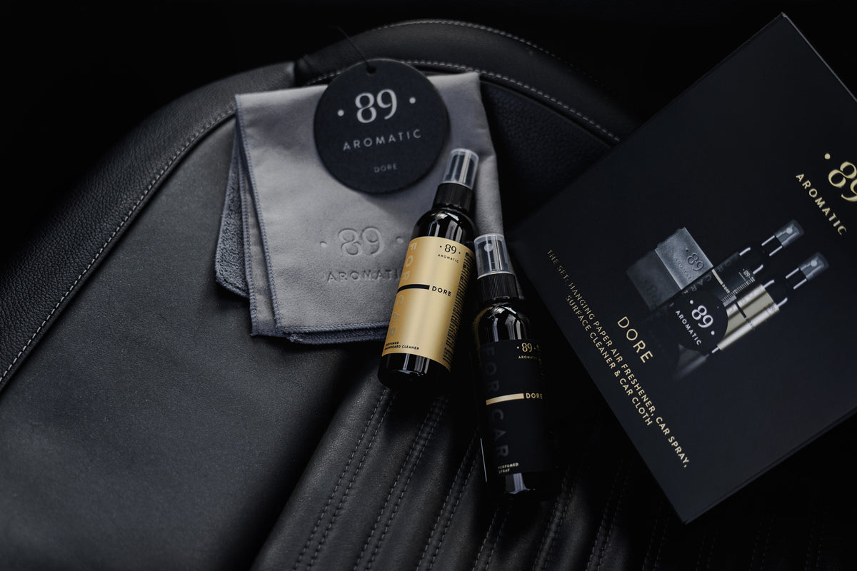 Aromatic 89 Car Care Set Dore, full set laid out on a leather seat