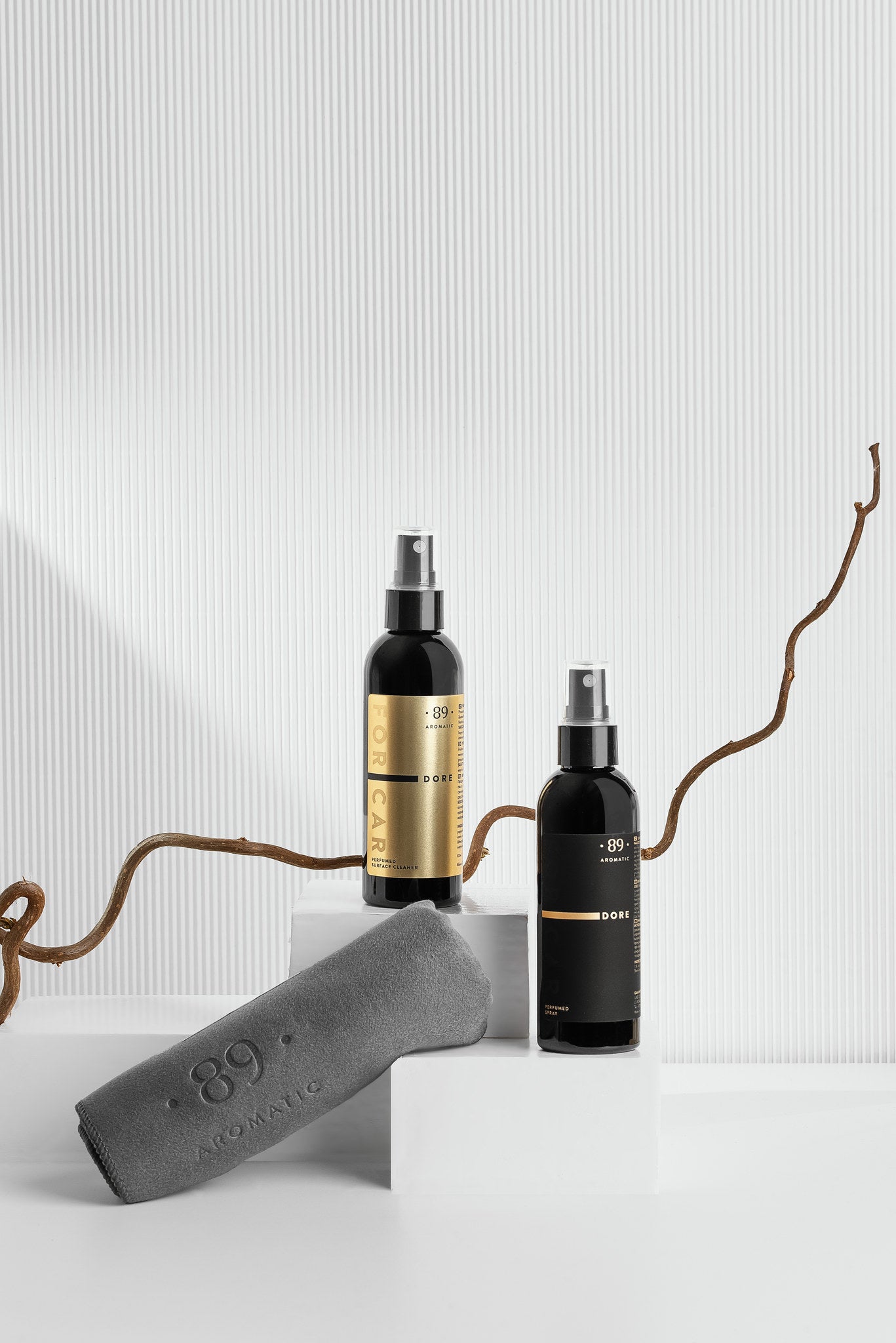 Aromatic 89 Car Care Set, perfume spray and surface cleaner on a white plinth