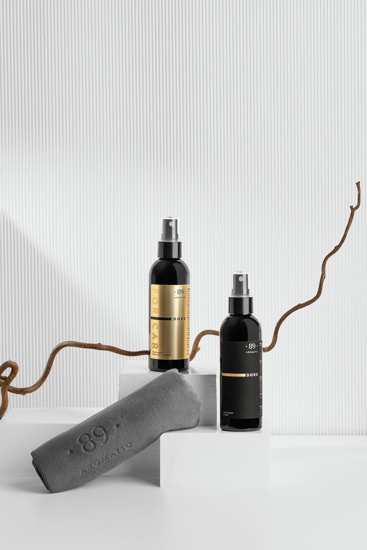Aromatic 89 Car Care Set, perfume spray and surface cleaner on a white plinth