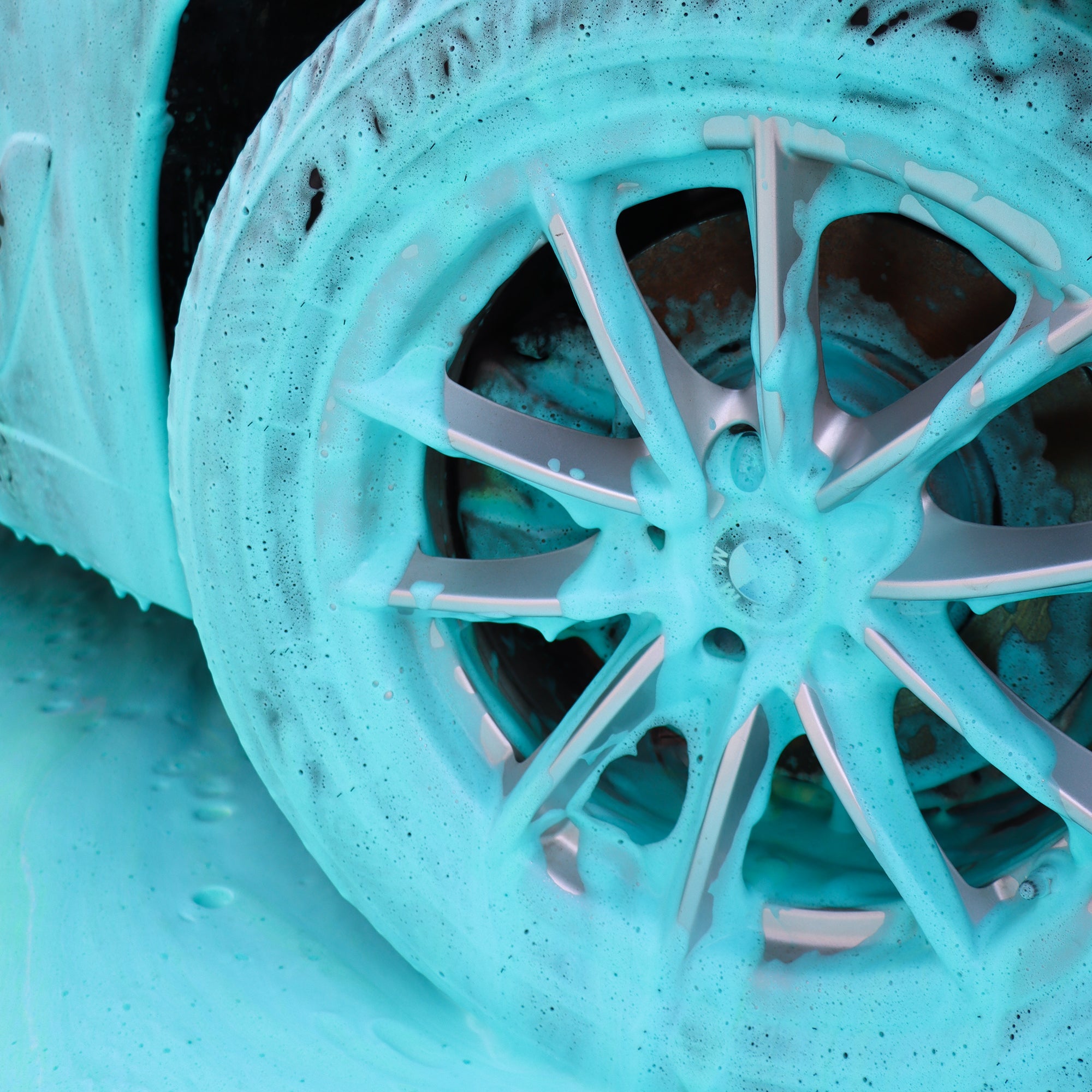 Blue coloured foam covering an alloy wheel and tyre, in use