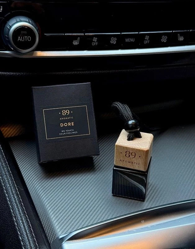 Aromatic 89 Hanging Glass Air Freshener 8ml Dore, bottle and box on the centre console