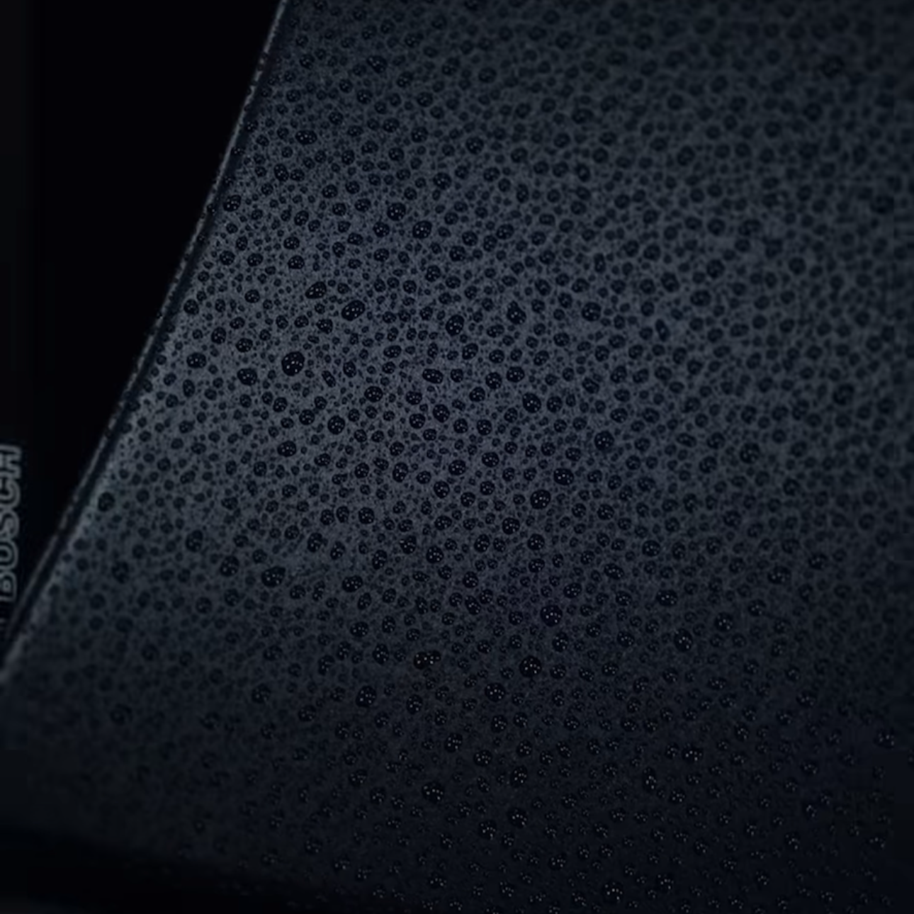 Water beading on matte trim protected with CarPro MadMatte — close-up