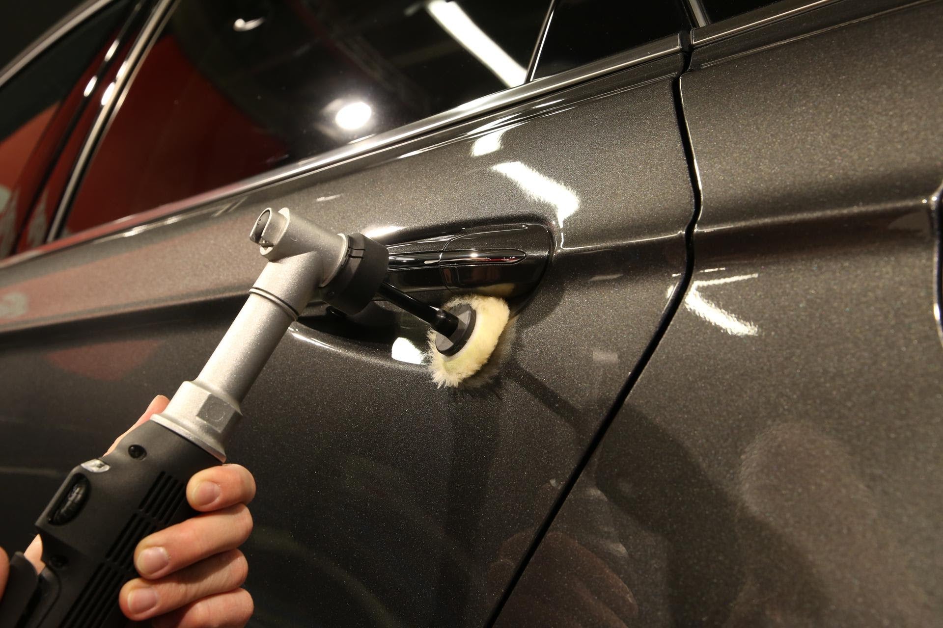 Rupes iBrid Nano Extension Bar in use polishing behind a door handle with a wool pad