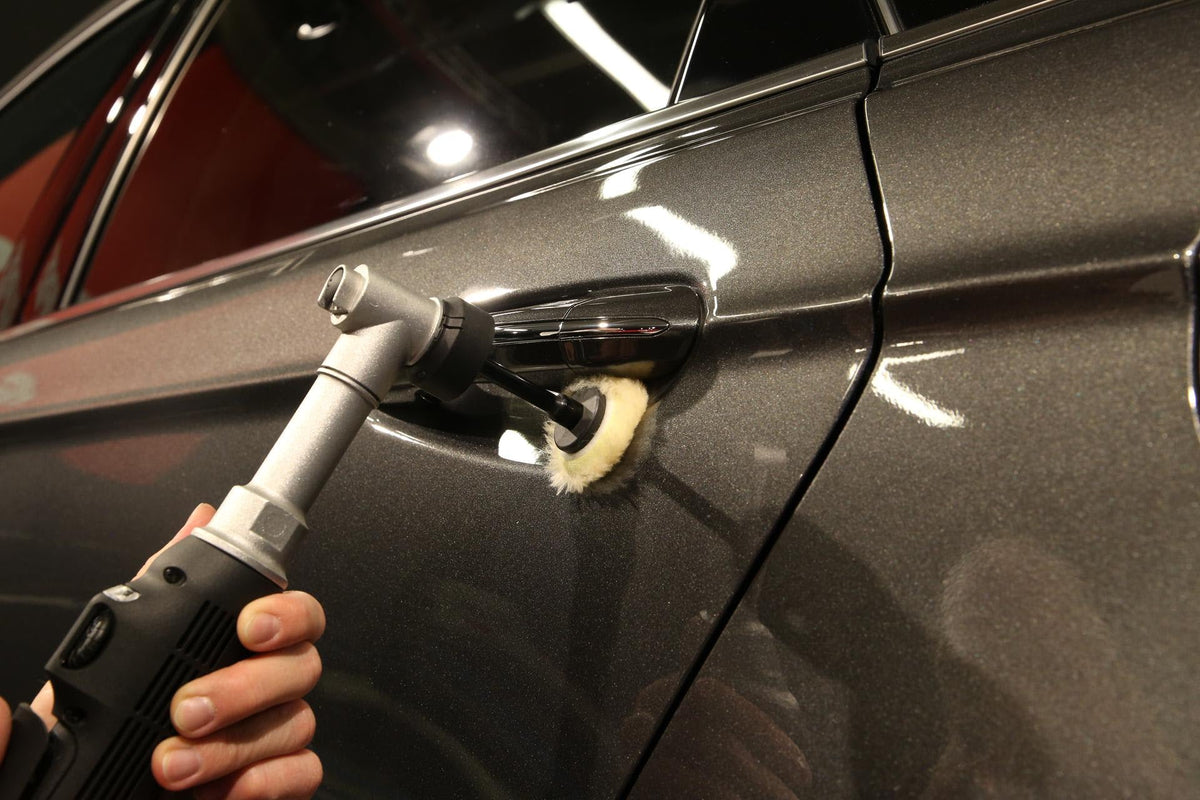 Rupes iBrid Nano Extension Bar in use polishing behind a door handle with a wool pad