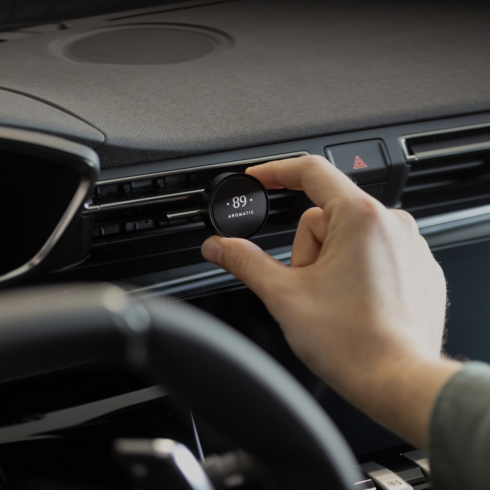Aromatic 89 Car Air Freshener Vent Clip, clipping onto the dashboard vent