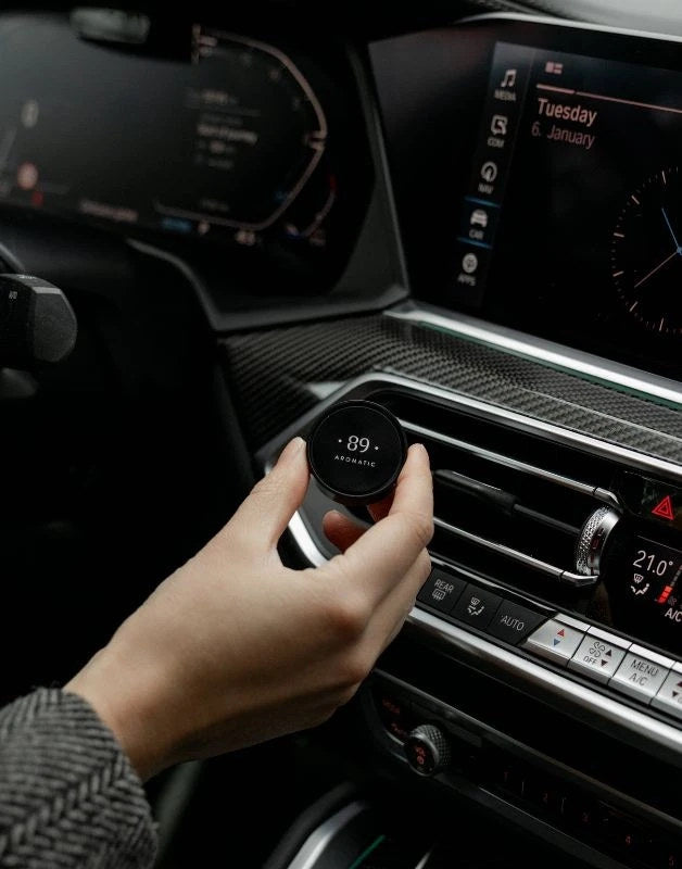 Aromatic 89 Car Air Freshener Vent Clip, fitting the clip in a BMW cabin
